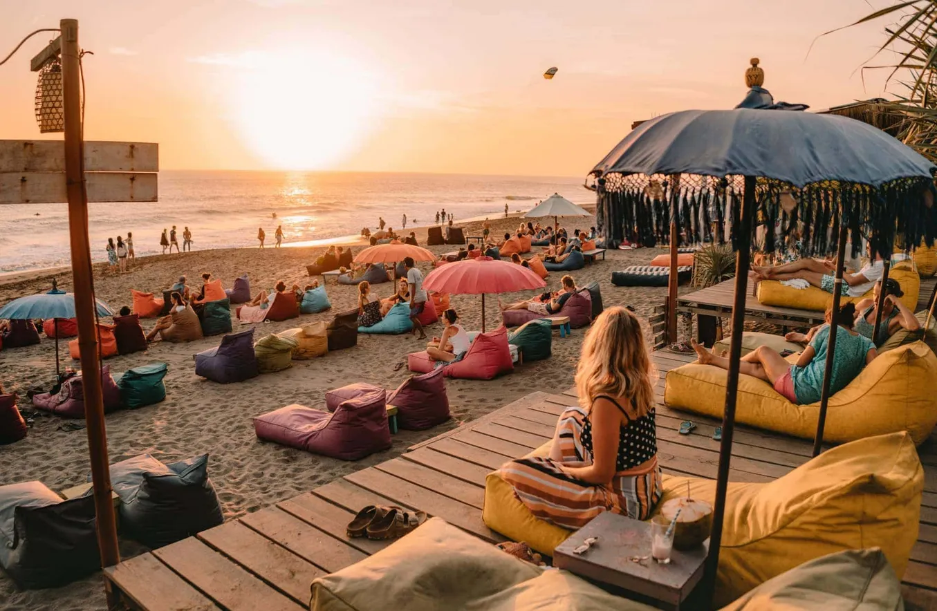 People enjoy the sunset on Canggu beach