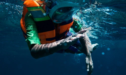 A man Snorkeling using life jacket